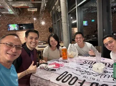 Linus with Clarence Chua and his table at a restaurant
