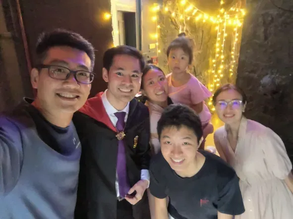 Linus in wizard robes with Daniel Sim and his family at Wizard's Brew