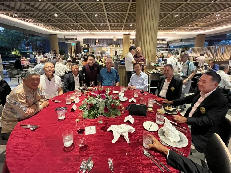Linus at a dinner table with ESM Goh Chok Tong and his guests