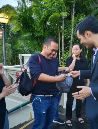 Guests reacting to a close-up trick at a corporate event