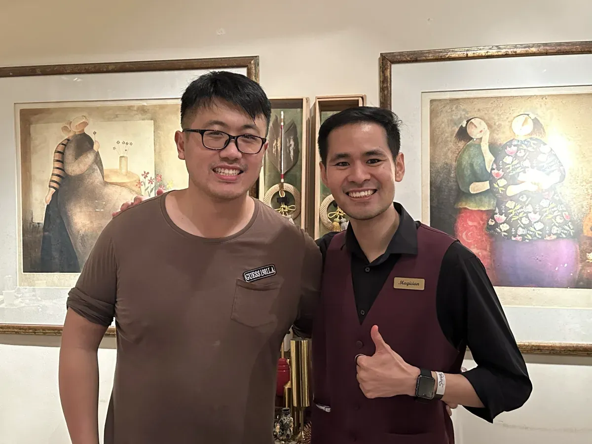 Linus giving a thumbs up beside Teoh Ren Jie at a private party