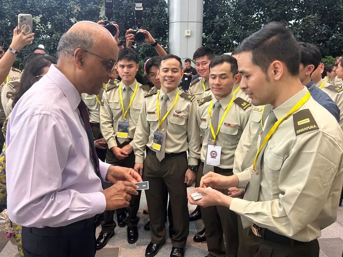 President Tharman Shanmugaratnam examining a card after a close-up trick by Linus